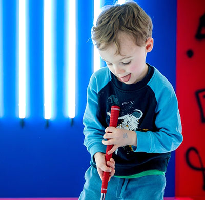 Small Kid Holding golf Cross