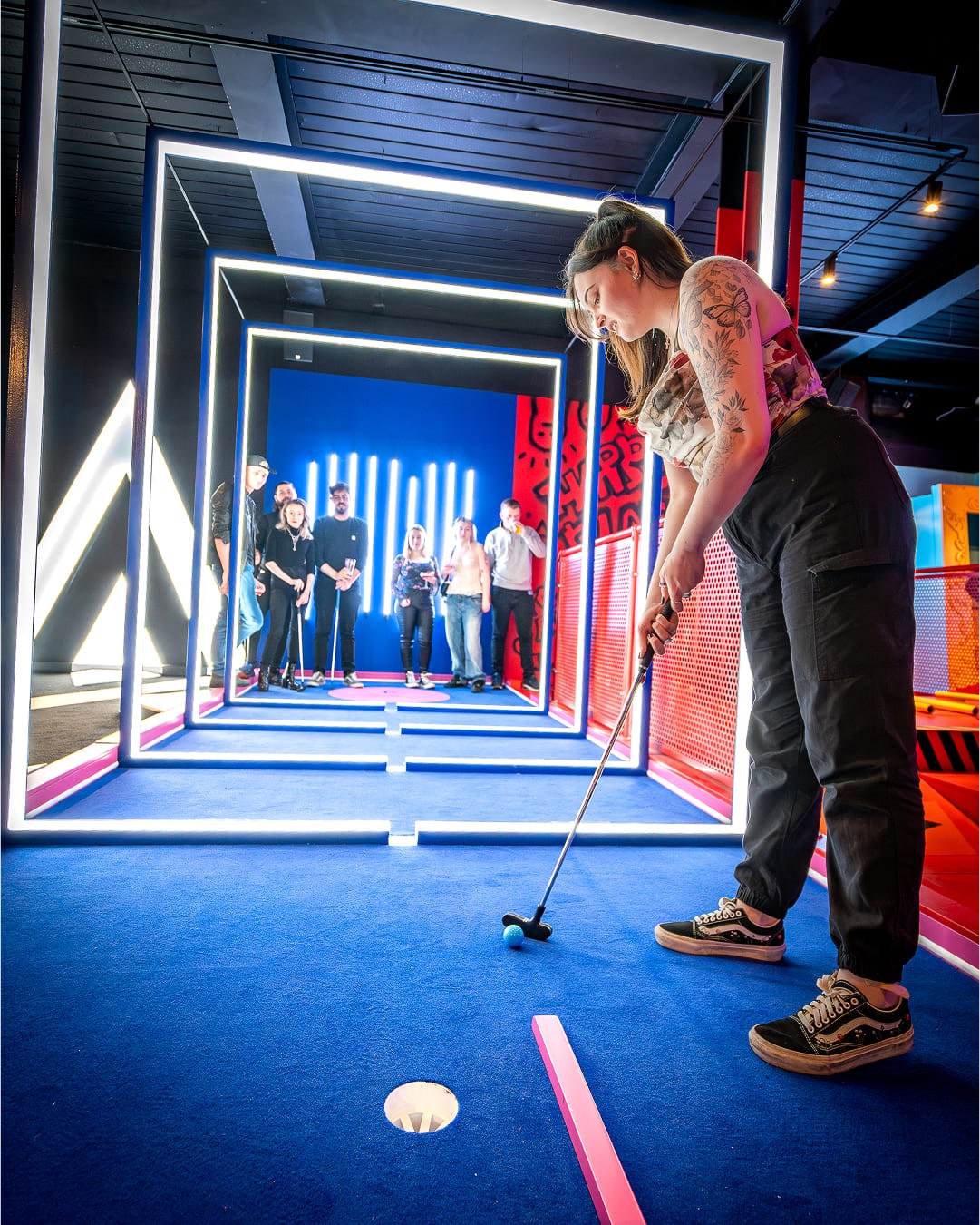 Woman playing mini-golf